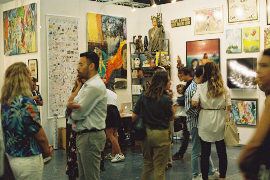 People exploring a lively art gallery with diverse artworks on display.