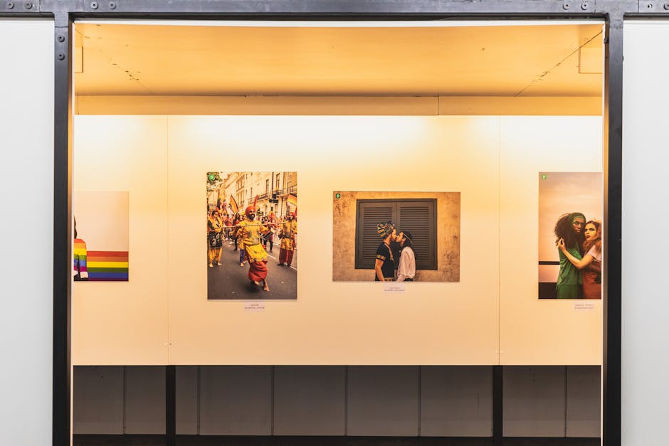 A colorful art exhibition showcasing LGBTQ+ themes with striking photographs and a pride flag.